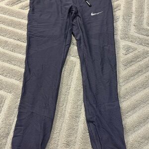 Nike Dri-FIT Pants with compression for the bum and mesh on the legs. NWOT